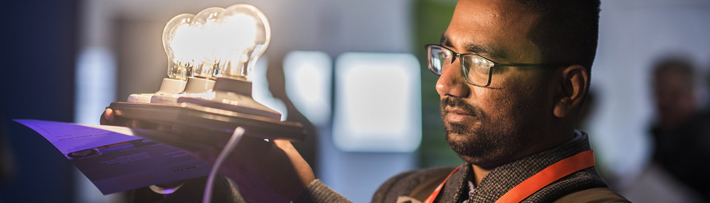 Man looking at graphene-enhanced lightbulbs